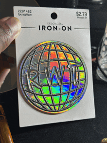 a person is holding an iron-on sticker that says rwt on it