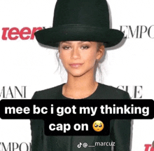 a woman wearing a black hat with a caption that says " mee bc i got my thinking cap on "