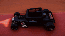 a black toy car with the word hot rod on the back