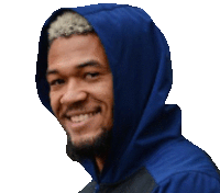 a man wearing a blue hooded jacket is smiling