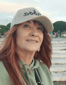 a woman wearing a white hat with the word poder embroidered on it