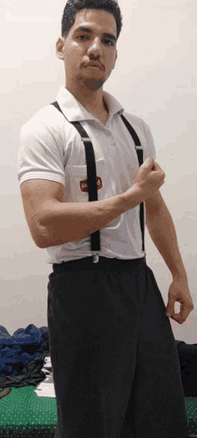 a man wearing suspenders and a white shirt with a red sticker on the pocket that says ' gm '