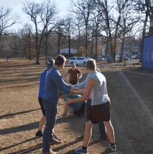 a group of young men are playing a game in a park with a blue container in the background that says co on it