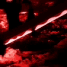 a person is standing in a dark room with a red light coming out of the ground .