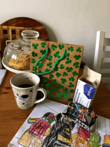 a box of metronidazole hydrochloride 50 mg sits on a table next to a cup of coffee