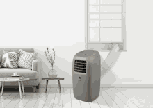 a portable air conditioner in a living room with a couch and table