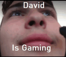 a close up of a man 's face with the words david is gaming