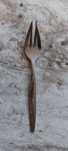 a fork with a floral design on the handle