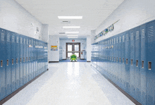 a row of blue lockers in a school hallway with a sign on the wall that says " exit "