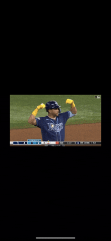 a baseball player for the rays is flexing his arms