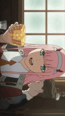 a girl with pink hair and blue eyes is holding a piece of cake in her hand