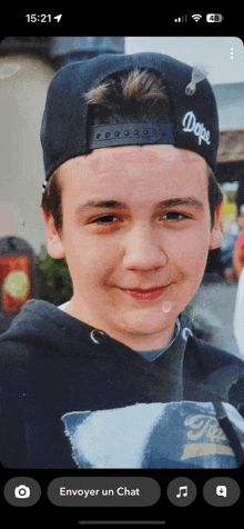 a young boy wearing a dope hat and a hoodie