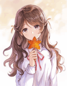 a girl with long hair is holding a leaf in her hand