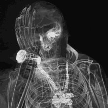 an x-ray of a skeleton wearing a watch and a necklace with the word meat on it