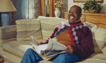 a man sits on a couch reading a newspaper that says ' chronicle ' on the front