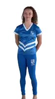 a woman wearing a blue shirt and black pants with a shield on the side of the pants