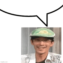 a man wearing glasses and a green hat is smiling and a speech bubble is above him .