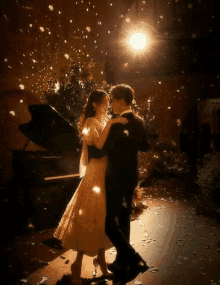 a bride and groom dancing in front of a piano