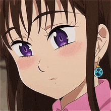 a close up of a girl 's face with purple eyes and earrings