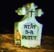 a gravestone with a cross and the words " atat s-a putet "