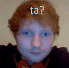 a close up of a man 's face with the word ta above his head