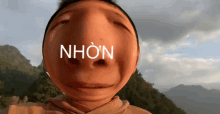 a person 's face with the word nhon written on it