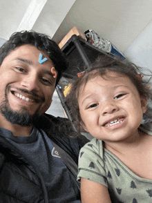 a man and a little girl are posing for a picture and the man is wearing a quiksilver shirt