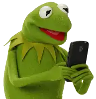 kermit the frog is holding a black cell phone in his hands