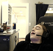 a person sleeping in a secret lab chair with their eyes closed