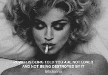 a black and white photo of a woman smoking a cigarette and a quote from madonna