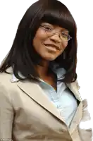 a woman wearing glasses and a tan jacket is smiling for a picture