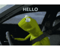 kermit the frog is sitting in the driver 's seat of a car saying hello