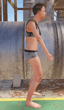 a man in a bikini is standing in front of a large metal pipe