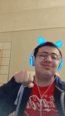 a man wearing headphones and a red shirt that says coca-cola