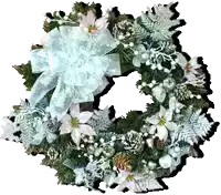 a christmas wreath with white flowers and a white bow