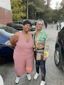 two women standing next to each other in a parking lot with a purse that says gucci on it