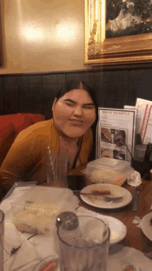 a woman sits at a table with a menu that says wine of the bottle