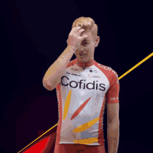 a man in a red and white cofidis jersey