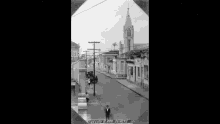 a black and white photo of a city street with a sign that says " hecho r pro duarte "