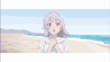 a girl with purple hair is standing on a beach with her hands on her chest