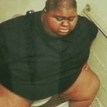 a very fat man is squatting on a toilet .