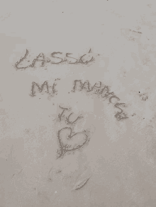 the word lassi is written in the sand