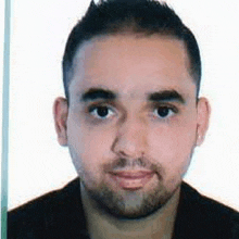 a close up of a man 's face with a beard .