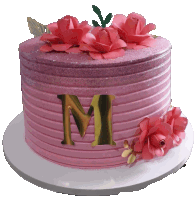 a pink cake with flowers and the letter m