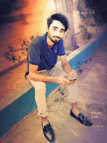 a young man sitting on a sidewalk with the words " i 'm the king of " written above him