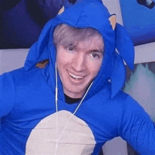 a man is wearing a blue sonic the hedgehog costume .