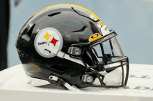 a black steelers football helmet sits on a table