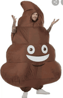 a man dressed in a poop costume with a smiling face