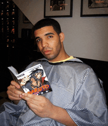 a man wearing a striped cape is reading a book called naruto