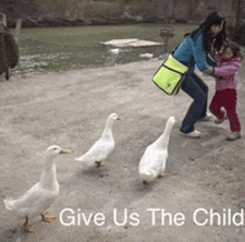 a woman and child feeding ducks with the words give us the child below